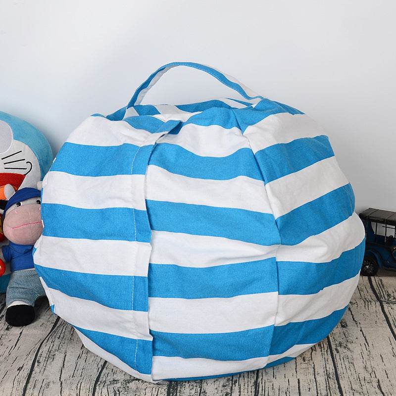 green and white striped canvas plush toy storage bag on wooden floor next to stuffed animal and toy car