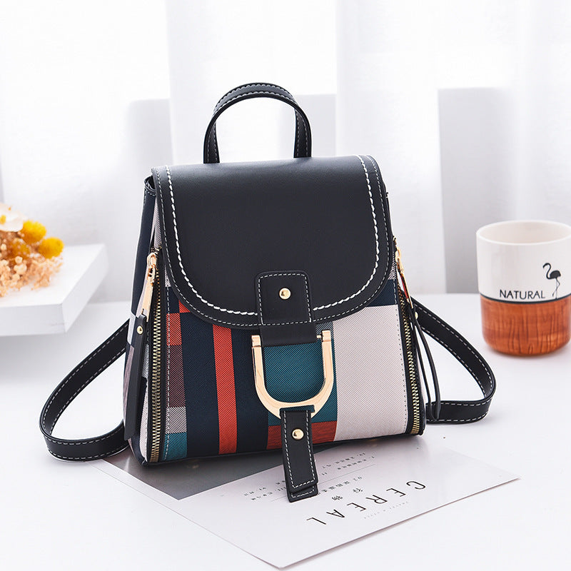 Female PU crossbody handbag with gold hardware, multicolor stripes, and black top flap, compact and stylish shoulder bag