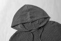 Grey men's hoodies sweater made of 65% cotton and 35% polyester with a textured pattern and drawstring hood