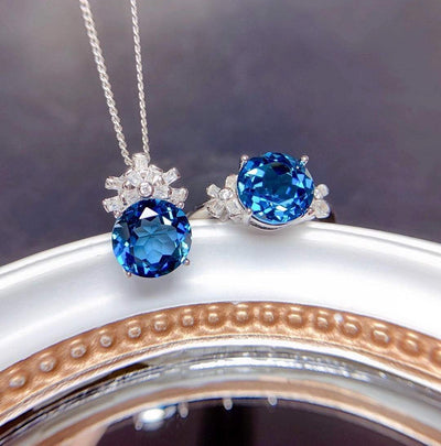Elegant women's jewelry set with London blue stone pendant necklace and matching ring