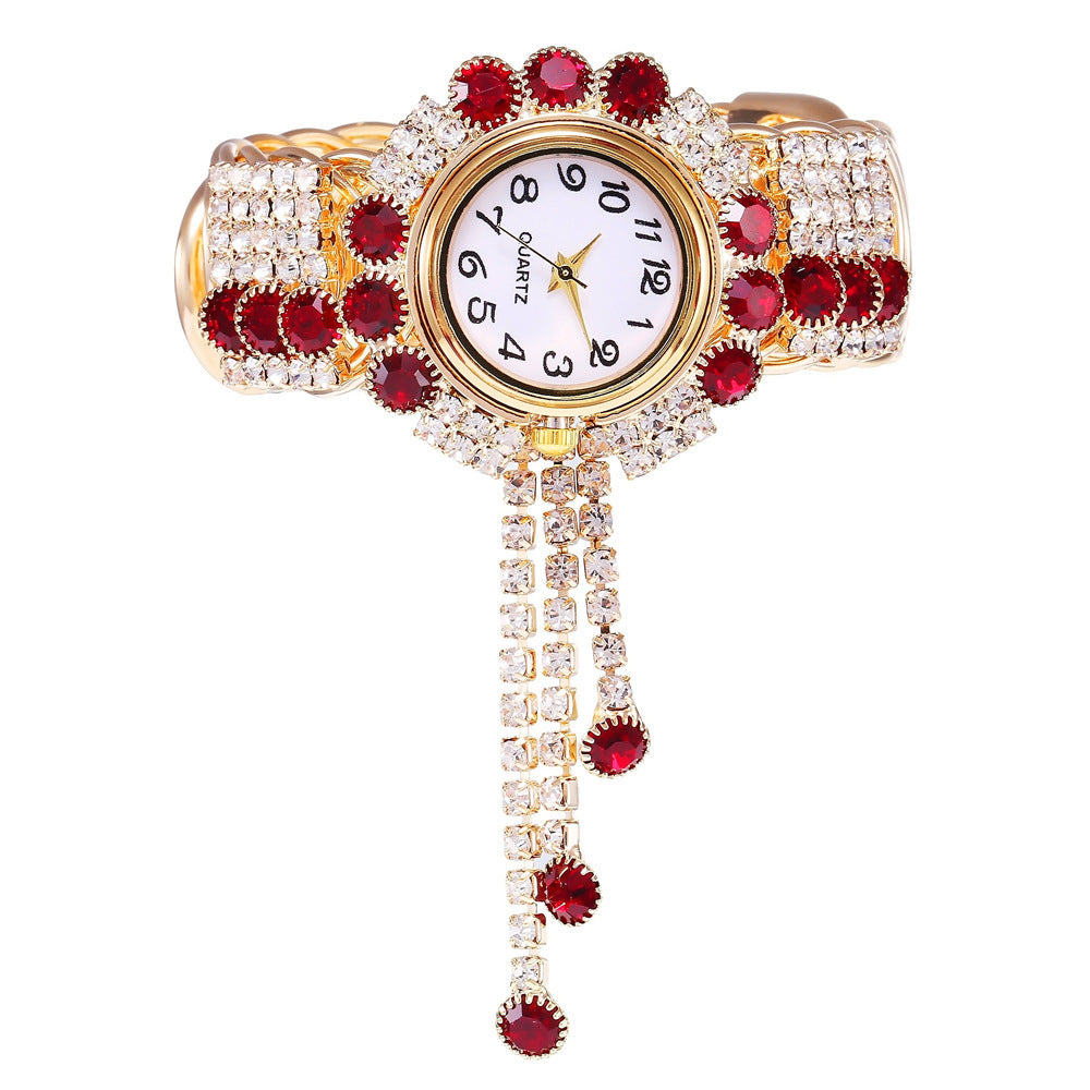 Trendy fashion quartz watch with red and clear crystals on gold bracelet band