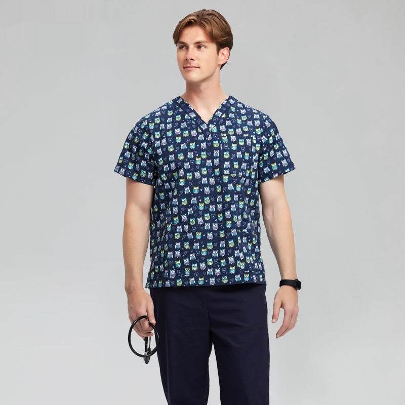 man wearing blue patterned chirurgische jas medical scrub top and navy pants with stethoscope on gray background
