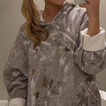 Casual damestop met zakken in lichtgrijs met planten- en bloemenprint, lange lantaarnmouwen en capuchon, los model pullover