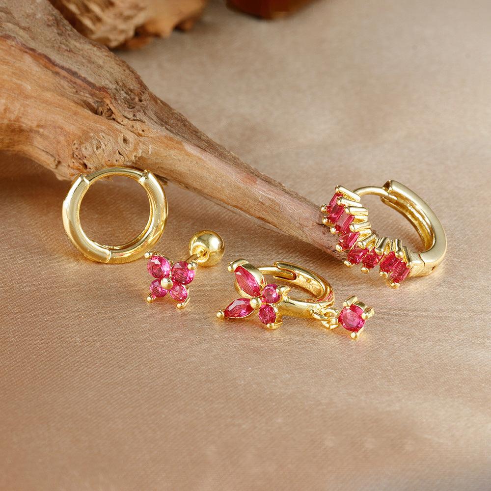 Close-up of ear wearing gold diamond butterfly ear ring and matching earrings set