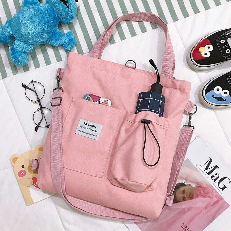 Roze Harajuku canvas tas met meerdere vakken en verstelbare schouderbanden, stijlvol en comfortabel draagbaar.