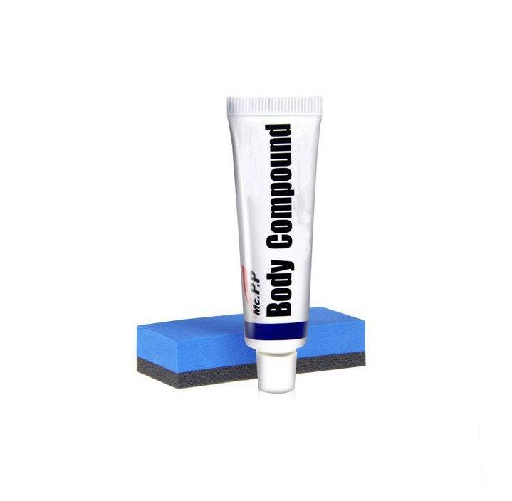 Tube of body compound and blue sanding sponge for car scratch removal Autokrassenverwijderaar