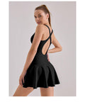 Woman wearing black dress made of Hoge Stretch fabric with open back and flared skirt