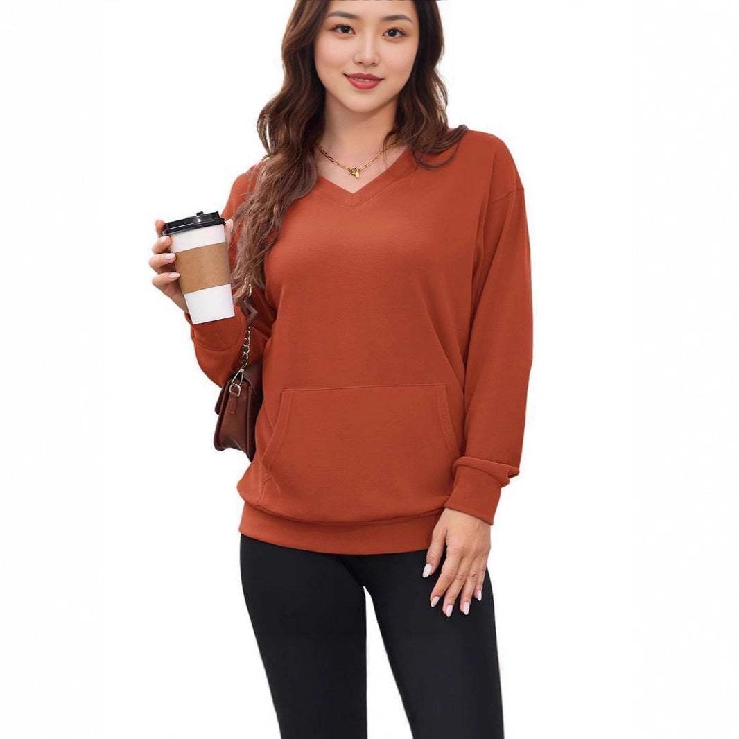 Women wearing pink loose pullover long sleeve autumn and winter top with black leggings holding coffee cup outdoors